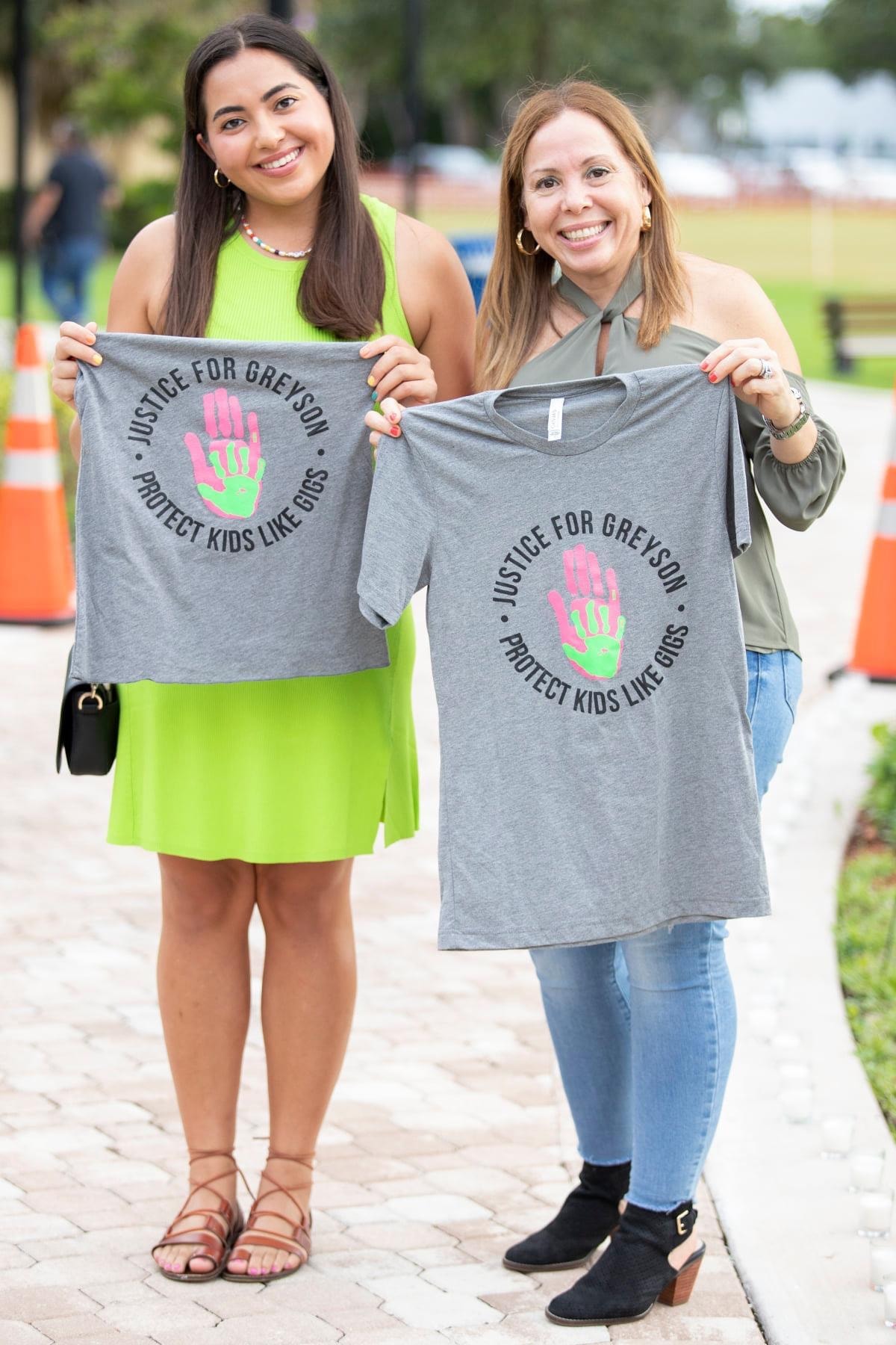 Two supporters wearing Justice for Greyson shirts